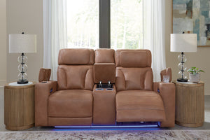 Loveseat reclinable de cuero marrón en un entorno de sala de estar con mesas auxiliares y lámparas.