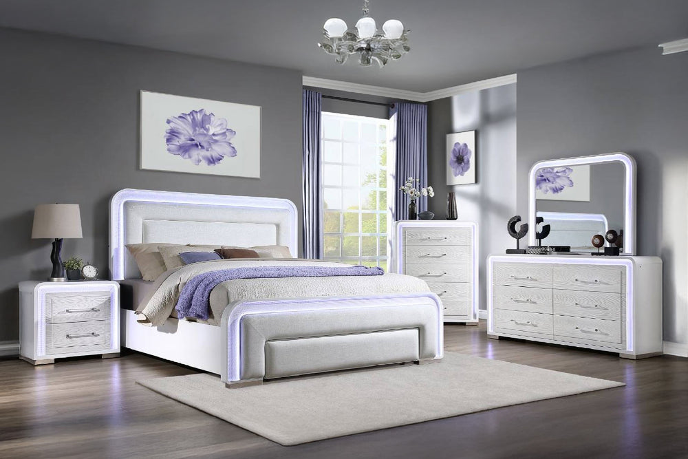 Modern bedroom with white furniture featuring a bed, a dresser with mirror, a chest and a nightstand with LED lights.