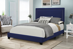 Blue upholstered bed with gray bedding in a bedroom setting.