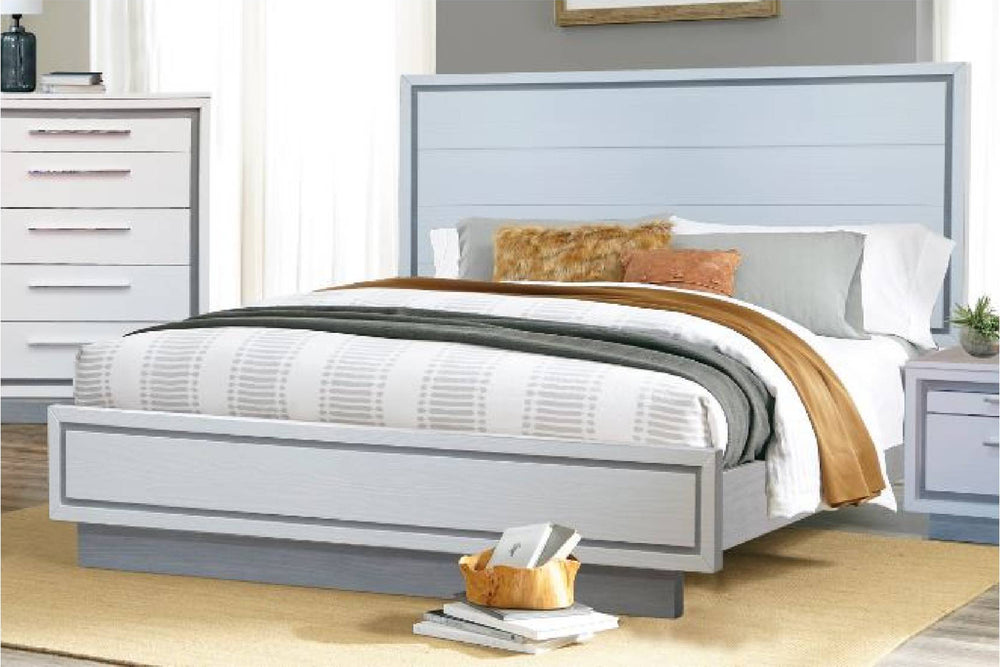 A white and silver bed with white bedding in a room setting.