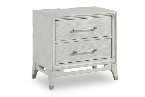 White, textured wood nightstand of two drawers with transparent handles and with a USB port on the back on a white background.