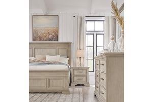 Front view of a portion of the rustic, wooden bedroom set featuring a bed, a nightstand to the right of the bed and the dresser with mirror on the right of the image.