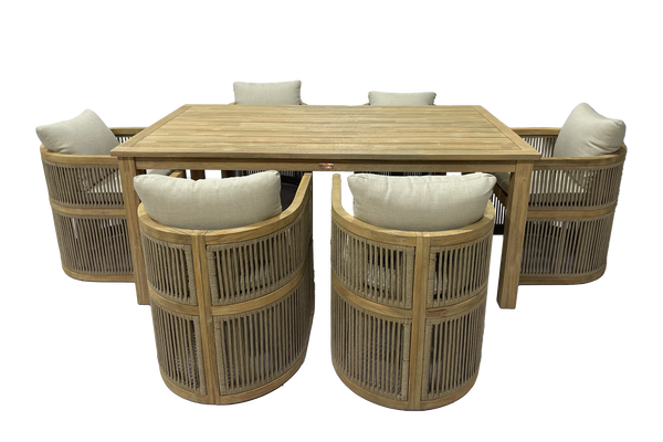 Beige wooden dining table with six matching beige and woven chairs with white cushions on a white background