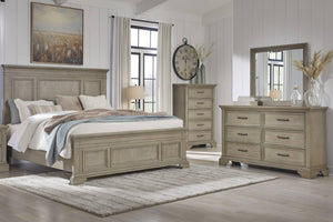 Rustic bedroom set featuring a bed, dresser with mirror, a nightstand and a chest in a well-lit room.