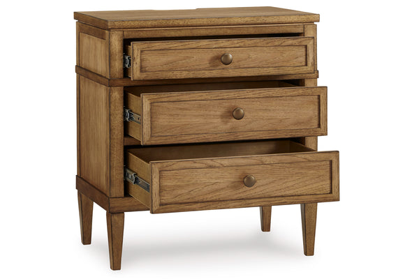 Sideview of a wooden nightstand of three open drawers on a white background.