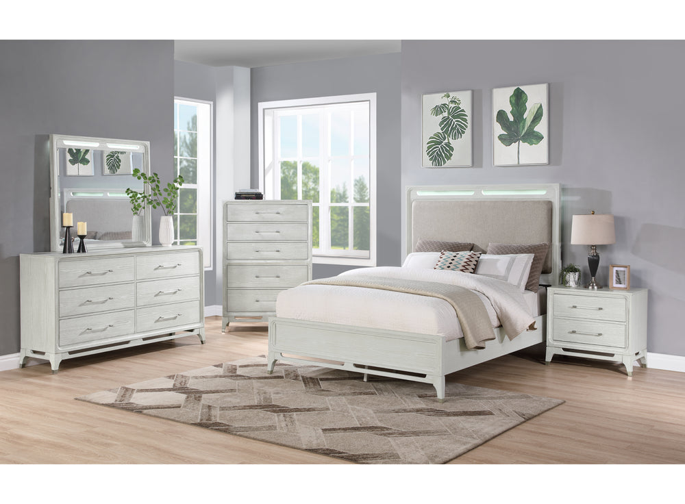 White, textured bedroom set with LED lights featuring a bed, a dresser with mirror, a nightstand and a chest in a bright room setting with windows.
