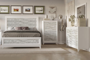A white, patterned wooden bedroom set featuring a queen bed, a chest and a dresser with mirror in a bright, white bedroom setting.