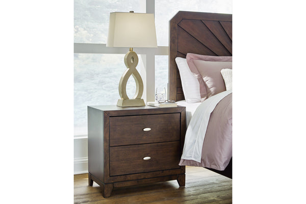 Dark brown, wood nightstand with two drawers in a bedroom setting next to a bed.