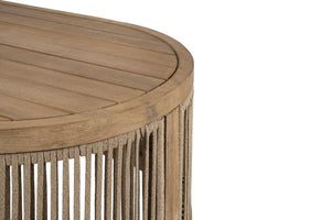 Close up of wooden side table with wicker base on a white background