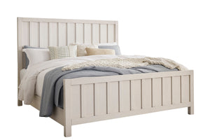 White bed with bedding on a white background.