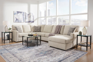 Seccional beige en sala de estar con grandes ventanales y elementos decorativos.