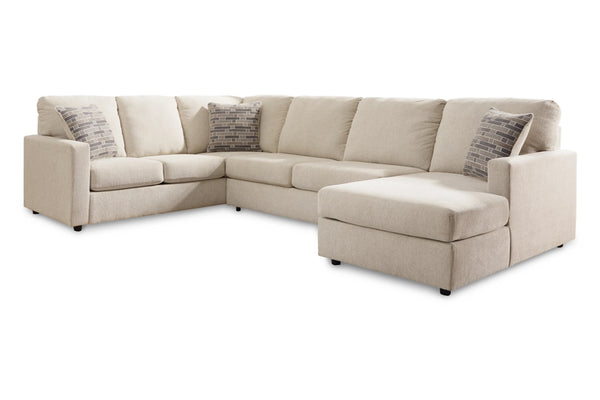 Seccional beige con cojines estampados sobre fondo blanco.