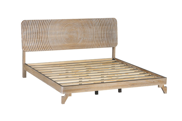 Vista lateral de estructura de cama de madera natural clara con base de listones y cabecero curvo con vetas de madera circulares concéntricas, mostrada sobre un fondo blanco liso.