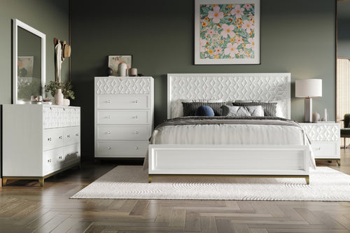 Conjunto de muebles de habitación de color blanco que incluye una cama, un chest, una mesa de noche y un gavetero con espejo en un habitación con elementos decorativos. 