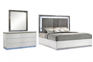 Juego de habitación de color blanco y plateado que incuye una cama y un gavetero con espejo sobre un fondo blanco. 