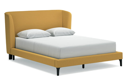 Cama amarilla con mattress y almohadas blancas sobre un fondo blanco.