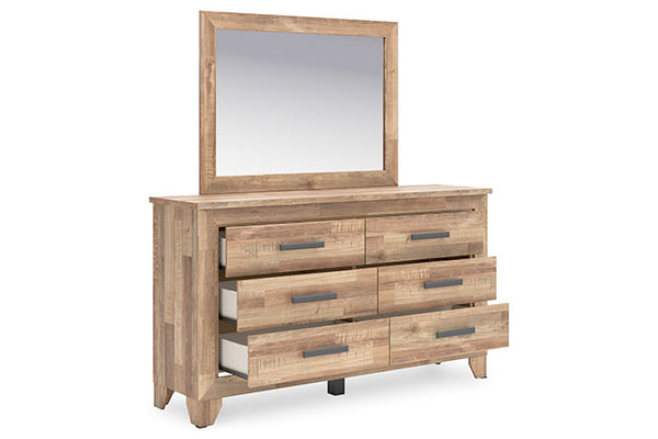 Gavetero de madera con espejo con las gavetas abiertas sobre fondo blanco