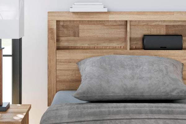 Cama con cabecero de madera y ropa de cama gris en un dormitorio