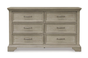 Gavetero de estilo clásico con madera marrón claro con seis gavetas con manijas horizontales de bronce sobre un fondo blanco. 