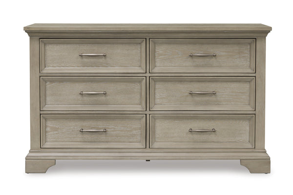 Gavetero de estilo clásico con madera marrón claro con seis gavetas con manijas horizontales de bronce sobre un fondo blanco. 