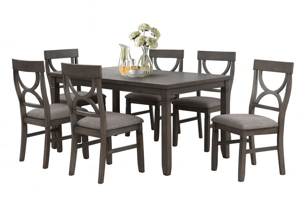 Juego de mesa de comedor con seis sillas sobre fondo blanco.