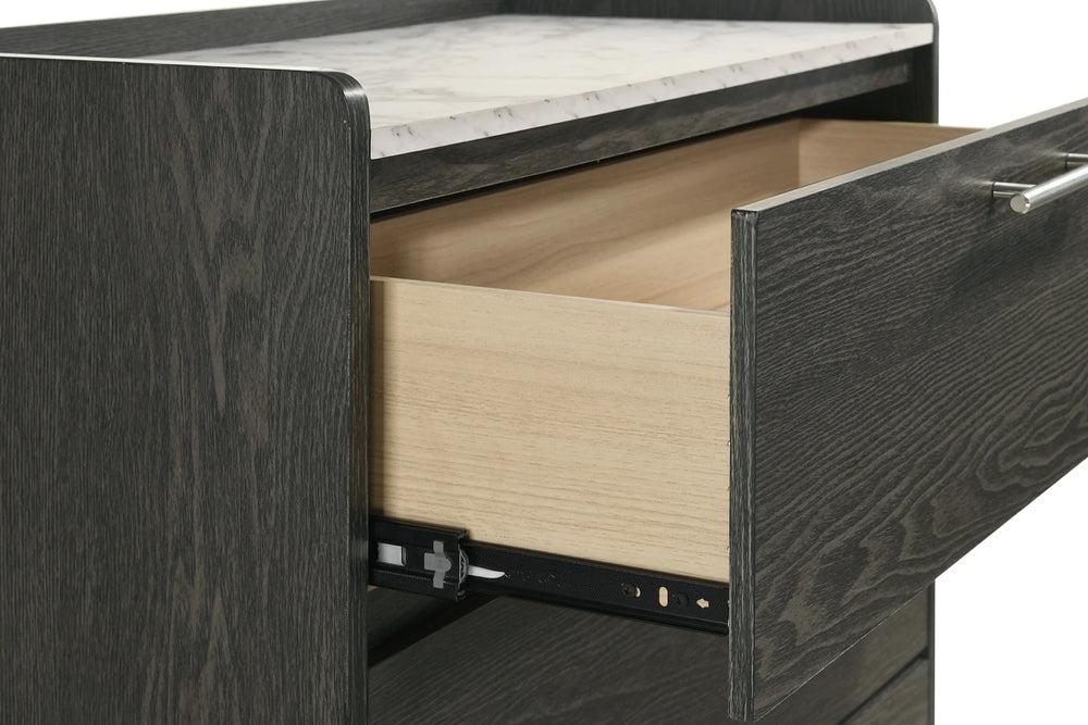 Black chest with four drawers with a marble pattern on the top on a white background. 