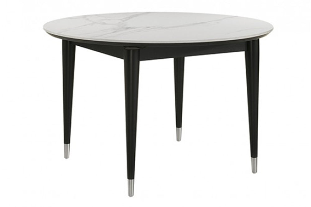 Mesa de comedor redonda con tablero tipo mármol y patas negras sobre fondo blanco.