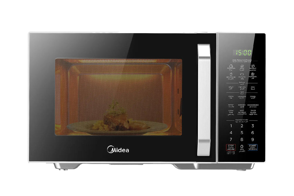 Microondas Midea color plateado y negro con puerta de vidrio, panel digital táctil al lado derecho y alimento calentándose en el interior sobre un plato giratorio.