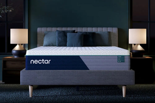 Mattress Nectar en un dormitorio con paredes oscuras y lámparas.