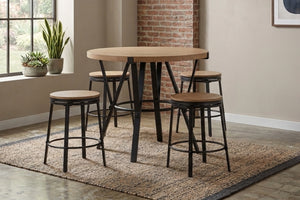 Juego de comedor tipo pub con mesa redonda de altura de mostrador y cuatro taburetes a juego. Diseño industrial con estructura metálica negra y superficie de madera clara, ubicado sobre una alfombra en un espacio de estilo urbano y acogedor.