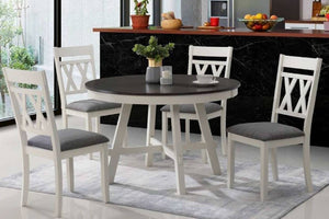 Mesa redonda en marco blanco con tope negro con cuatro sillas con acolchado gris en marco blanco en una sala de comedor moderno. 