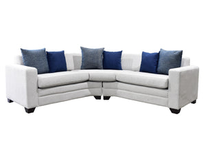 Seccional con cojines azules y grises sobre fondo blanco.