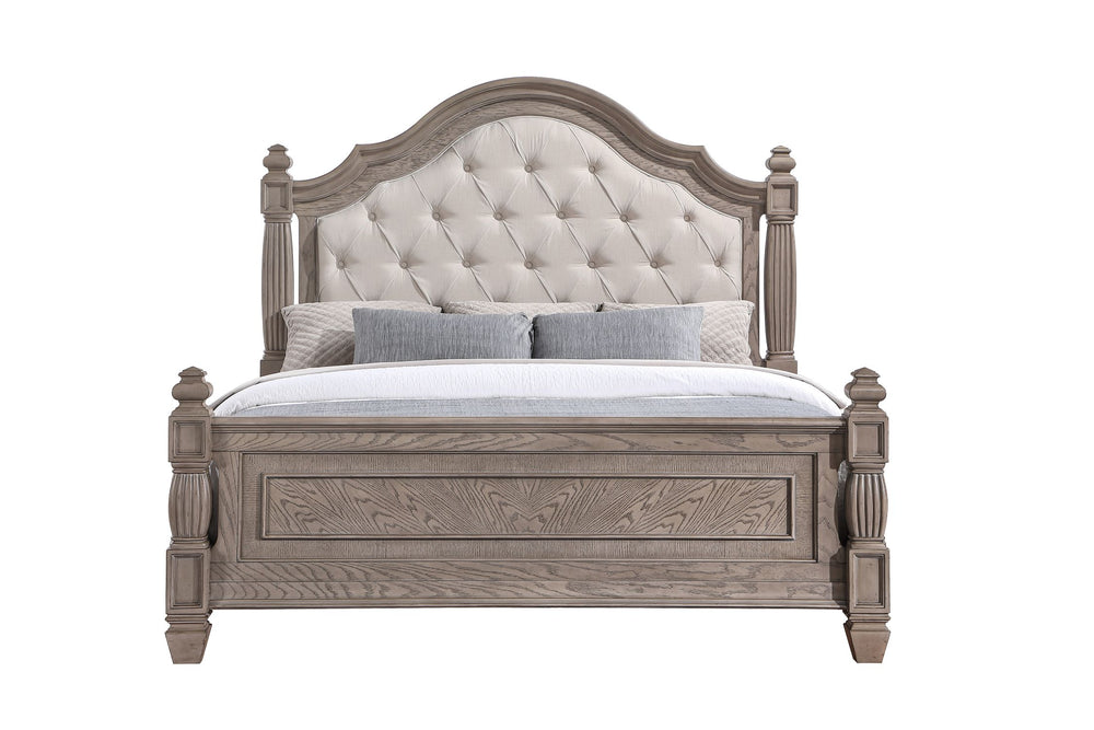 Un marco de cama de madera de estilo rústico con una cabecera capitonée en color crema, mostrado sobre un fondo blanco. La cama está decorada con ropa de cama blanca y dos cojines decorativos grises.
