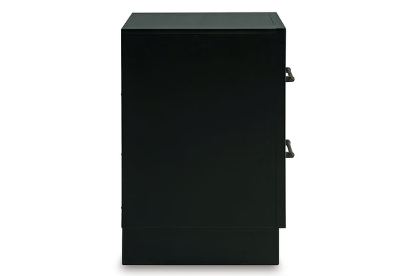 Vista lateral de mesa de noche enmarcado en negro con dos gavetas sobre un fondo blanco. 