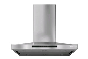 Campana extractora KitchenAid de pared en acero inoxidable con diseño tipo chimenea, iluminación LED integrada y controles electrónicos frontales. Ideal para eliminar humo, olores y vapores en cocinas modernas.