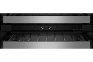 Primer plano del panel de control de una nevera de vino empotrable KitchenAid con frontal de acero inoxidable, tira de control negra, pantalla digital que muestra 50 y 64.