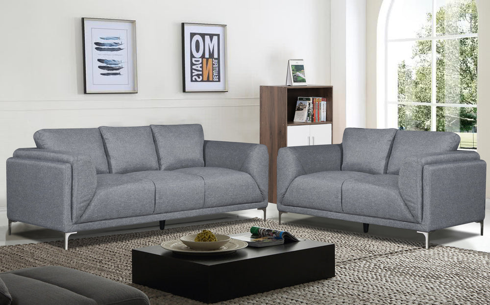 Sofá y loveseat de color gris en una sala con elementos decorativos. 