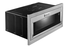 Un microondas empotrable KitchenAid con exterior de acero inoxidable y puerta con ventana negra, mostrado en ángulo sobre un fondo blanco.