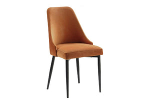 Silla de comedor tapizada con respaldo y asiento curvos en terciopelo de un cálido tono marrón camel, sostenida por patas finas de metal negro y presentada sobre un fondo blanco liso.