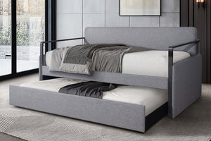 Cama tapizada en gris con cama nido extraíble en una habitación moderna.