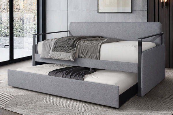 Cama tapizada en gris con cama nido extraíble en una habitación moderna.
