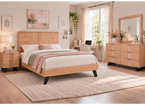 Set de muebles de dormitorio en madera clara con cama, mesa de noche, gavetero y espejo, presentado en una habitación moderna y luminosa con paredes beige, alfombra tejida grande y luz natural suave.