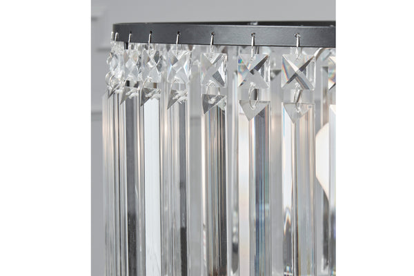 Pantalla de lámpara de cristal con dibujos de estrellas sobre fondo blanco.