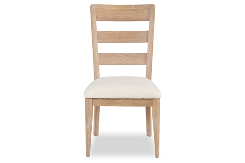 Silla de madera con cojín blanco sobre fondo blanco.