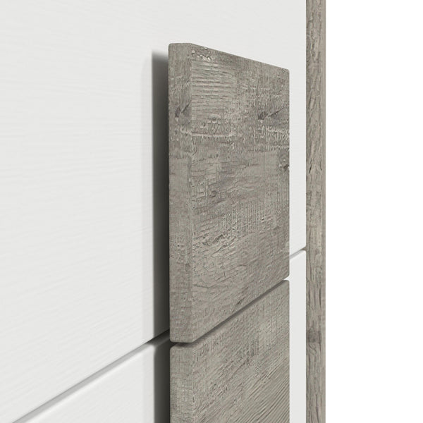 Vista cercana de cabecera de cama de colores blanco y gris claro. 