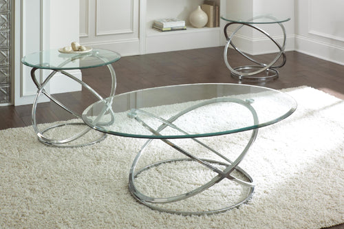 Chrome orbital-base glass coffee table set with oval and round tops on white shag rug.