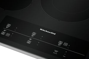 Primer plano de un tope de cocción eléctrica KitchenAid con panel de control.