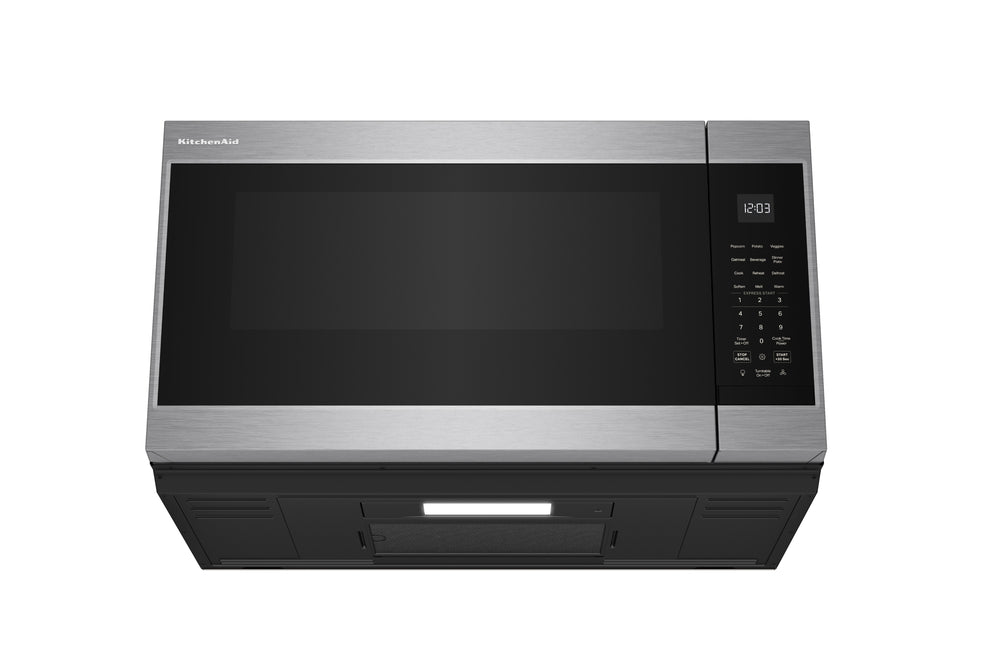 Horno microondas con extractor de acero inoxidable sobre fondo blanco