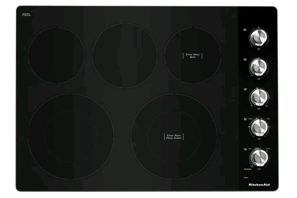 Tope KitchenAid con superficie vitrocerámica negra, cinco zonas de cocción eléctricas y controles giratorios laterales. Diseño moderno y elegante ideal para cocinas contemporáneas y espacios integrados.