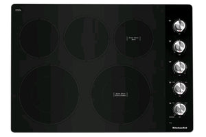 Tope KitchenAid con superficie vitrocerámica negra, cinco zonas de cocción eléctricas y controles giratorios laterales. Diseño moderno y elegante ideal para cocinas contemporáneas y espacios integrados.